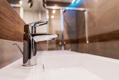 Modern Bathroom Sink Faucet Closeup Photo.