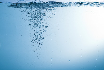 Flowing water, drops, sprays, splashes on a neutral background, studio light, abstraction, minimalism